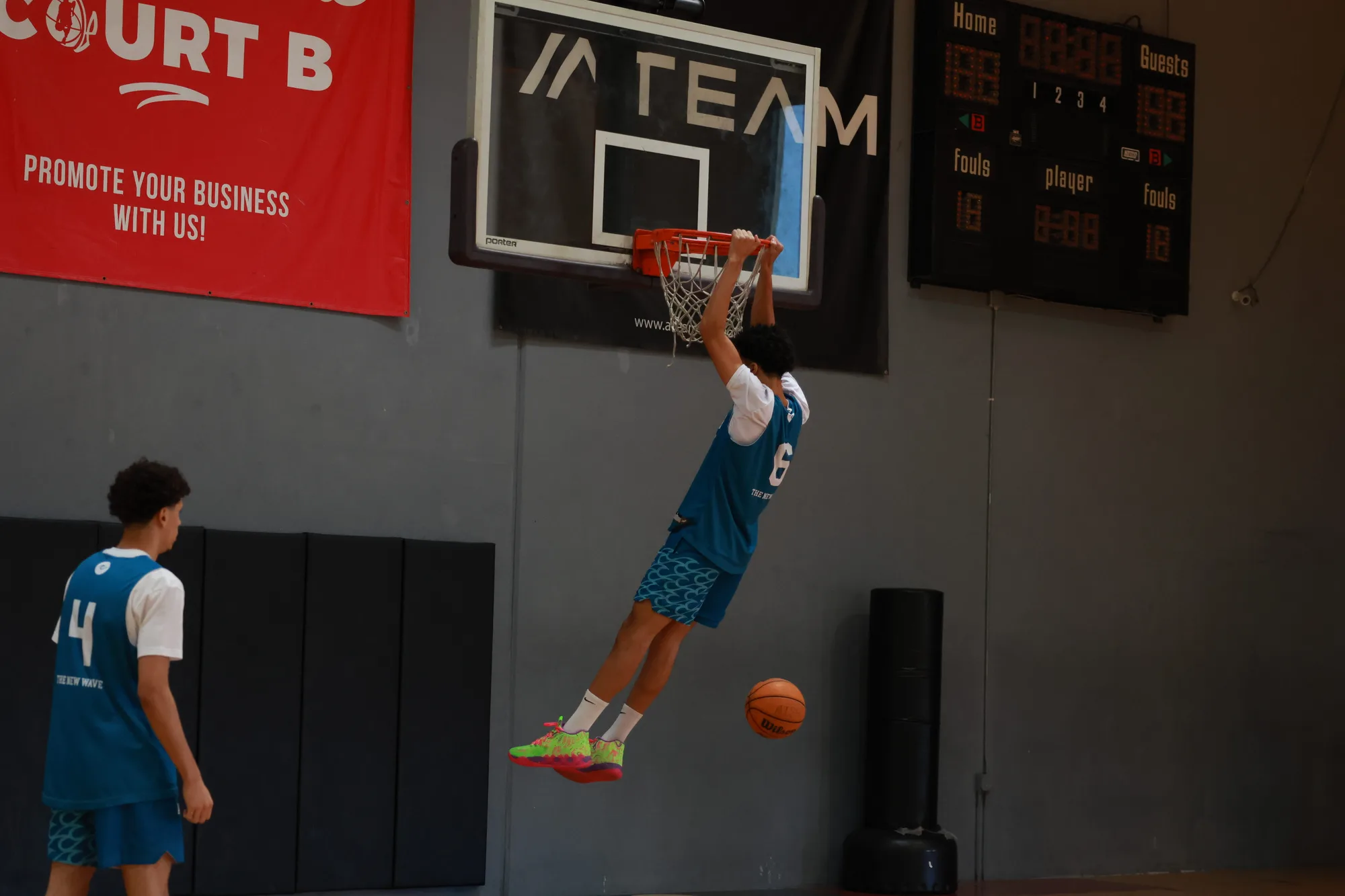 An Apex student-athlete finishing a dunk at the rim
