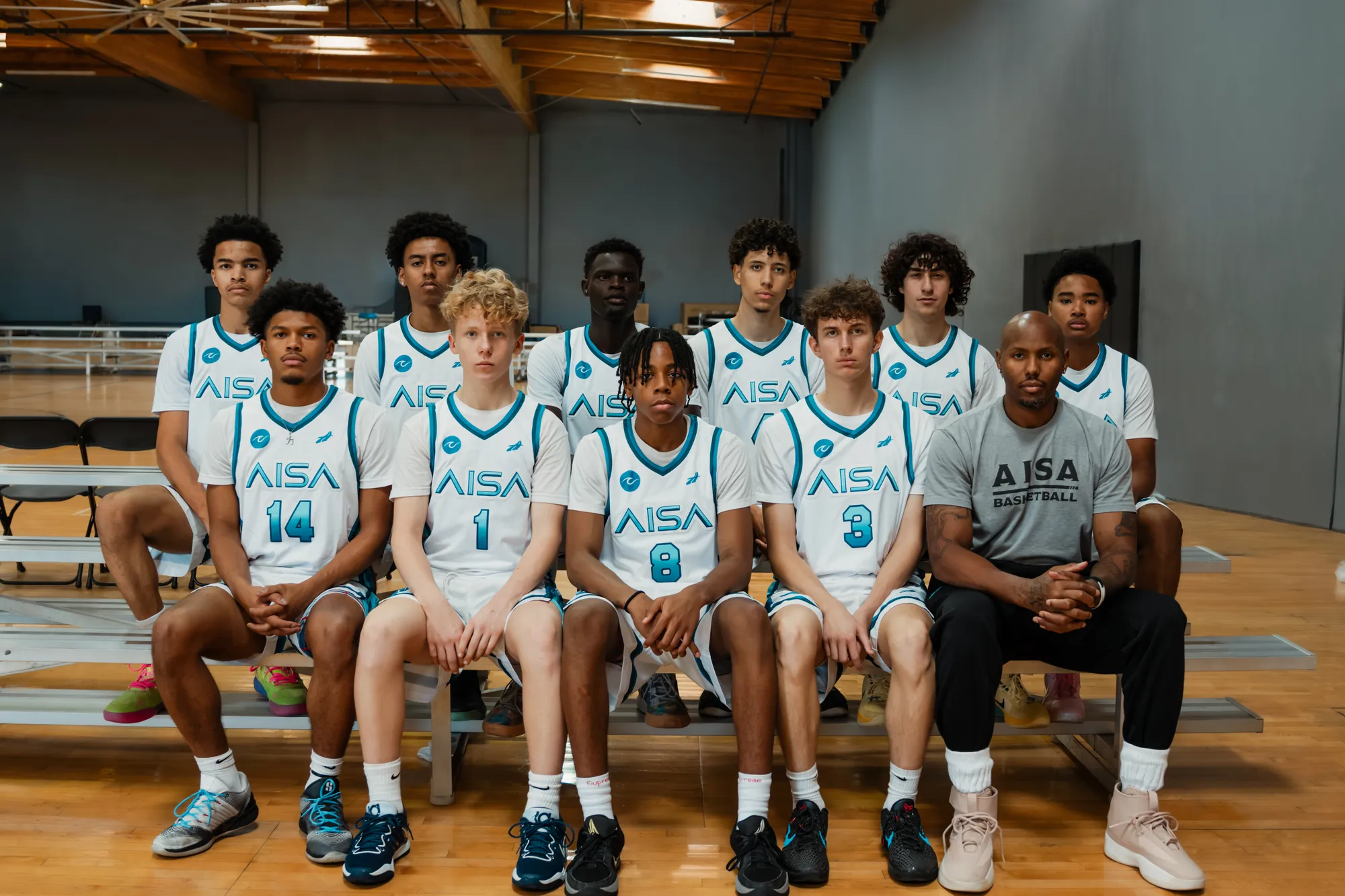 The Apex team seated together in the gym
