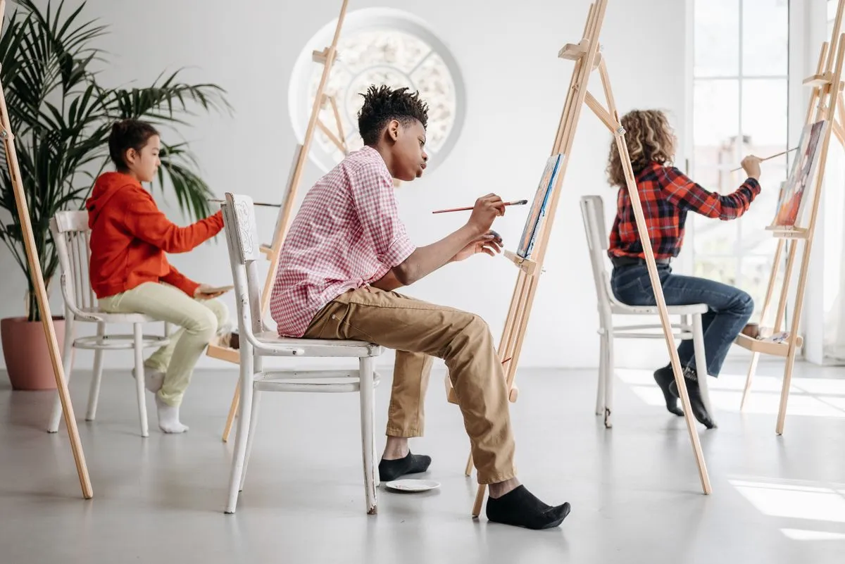 Students painting at easels in art class
