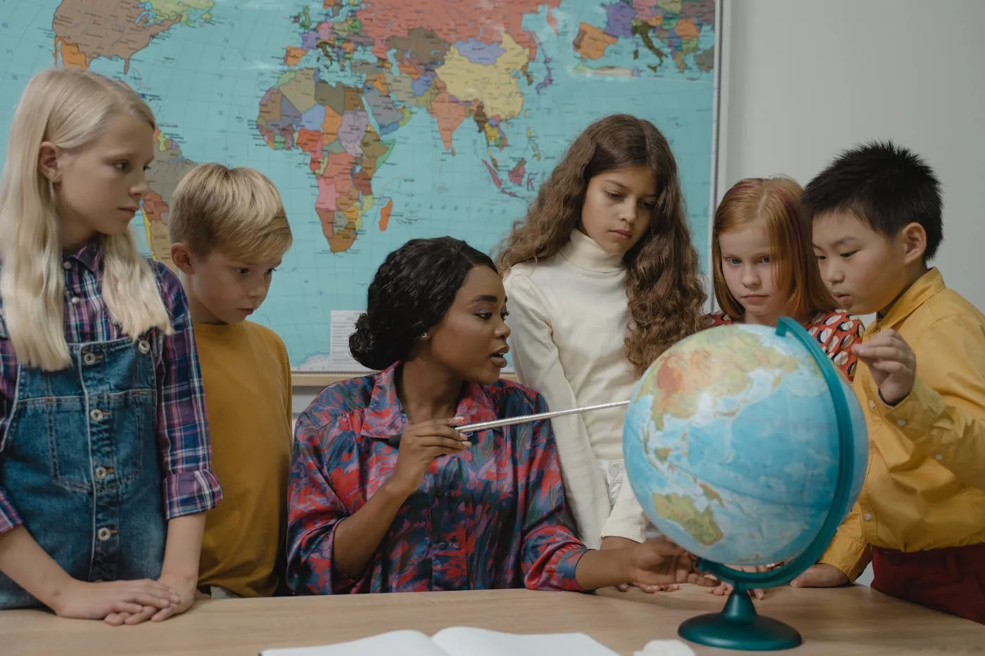 A teacher and students exploring the world together