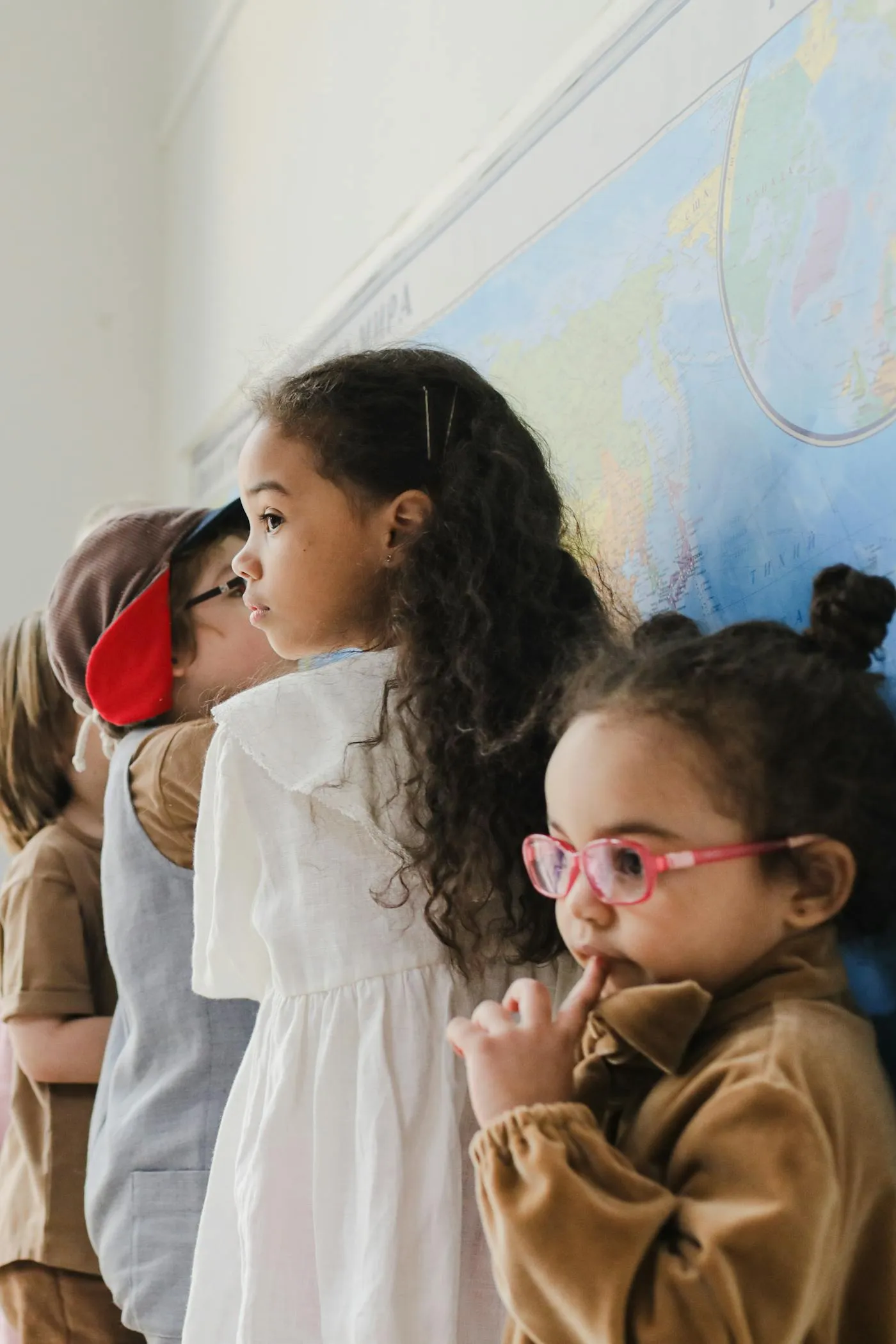 Children discovering the world on a classroom map